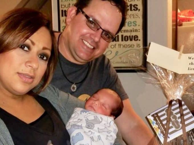 in-vitro-fertilization-treatment-beyond-infertility-husband-and-wife-holding-their-baby-born-by-ivf